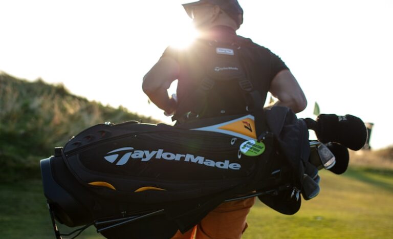 A man carrying a golf equipment bag. The different types of golf bags